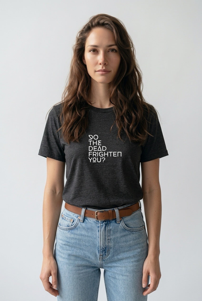 Woman wearing a black t-shirt with text, standing against a plain background
